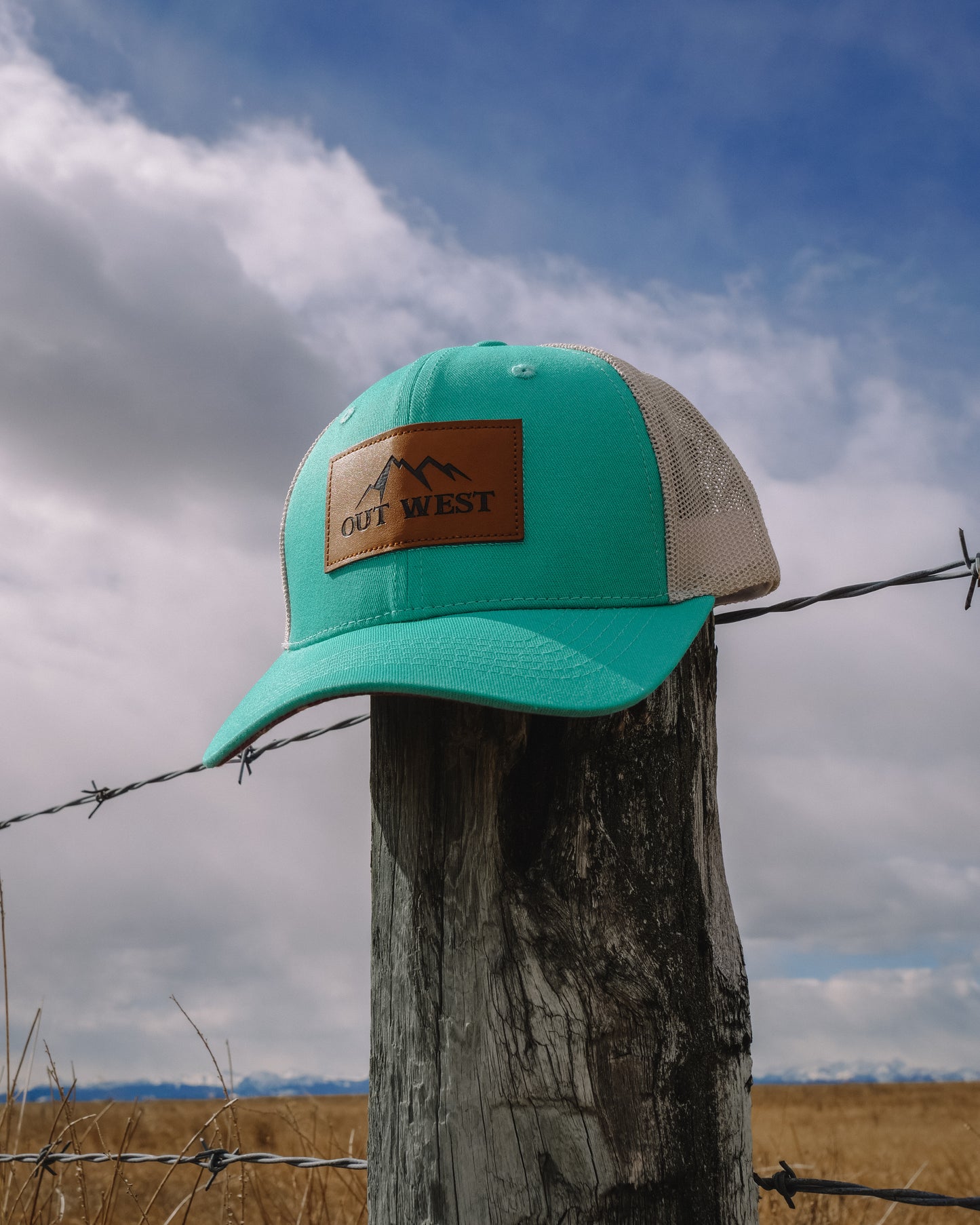Out West ball cap in Aqua- Our in-demand trucker caps are finally here + proudly designed by Out West! Not only fun & functional but truly a stylish staple piece for any rancher! A gorgeous aqua color with a light cream mesh back & adjustable strap.