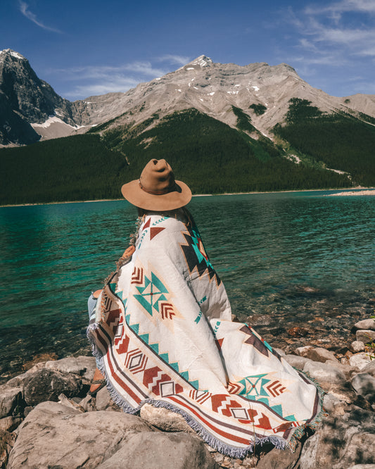 Aztec geometric western style throw rug- The perfect blanket for those cozy cold nights under the stars next to the campfire! Suited for every occasion from picnics, rodeos, camping, van life, yoga, and even beach trips! Or simply place it on your couch or bed for a splash of color to the room!  Color: White and earthy colors