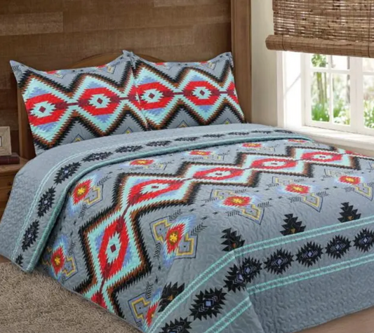 Grey Navajo  3-piece Bedspread Set-  This western quilt is stunning with a grey background and stunning geometric pattern in red, black and turquoise.  Each set includes the quilt (comforter) + 2 pillow-cases.  Size:  Queen: 90" x 90" 2 Pillow Covers: 20" x 26" + 2" King 106" x 94" 2 Pillow Covers: 20'' x 36'' + 2"