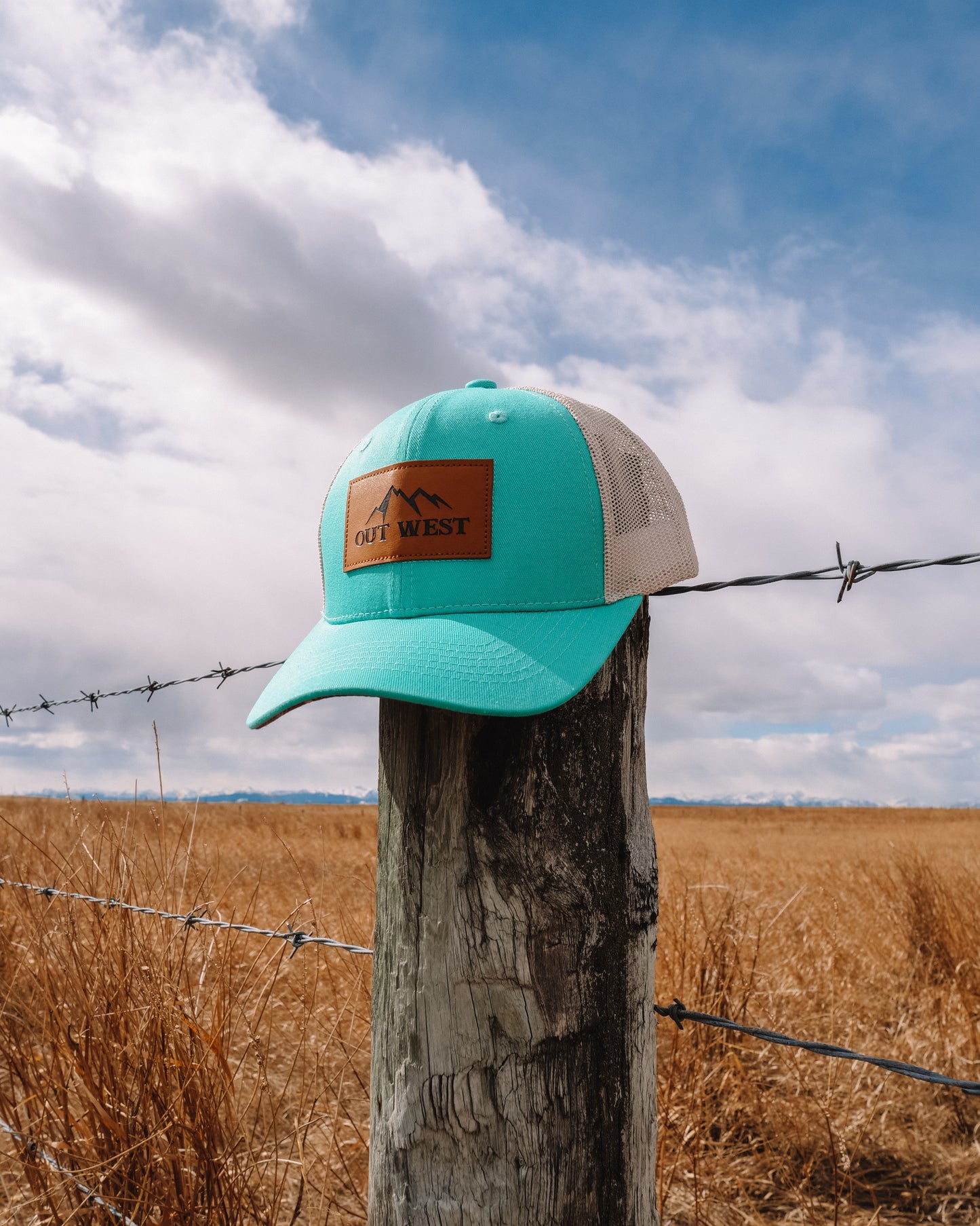 Out West ball cap in Aqua-  Our in-demand trucker caps are finally here + proudly designed by Out West! Not only fun & functional but truly a stylish staple piece for any rancher!  A gorgeous aqua color with a light cream mesh back & adjustable strap.