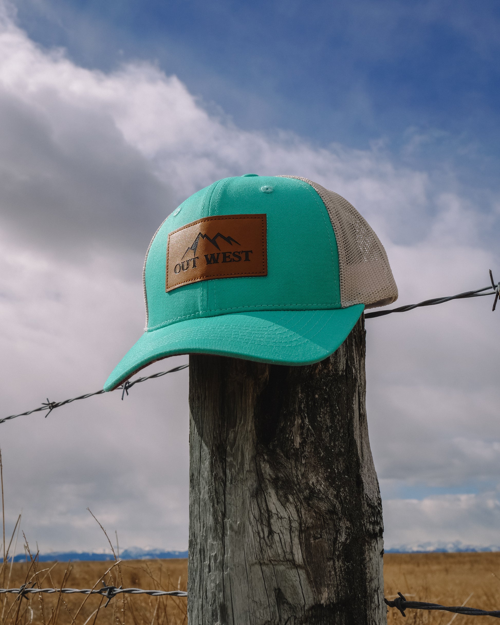 Out West ball cap in Aqua-  Our in-demand trucker caps are finally here + proudly designed by Out West! Not only fun & functional but truly a stylish staple piece for any rancher!  A gorgeous aqua color with a light cream mesh back & adjustable strap.