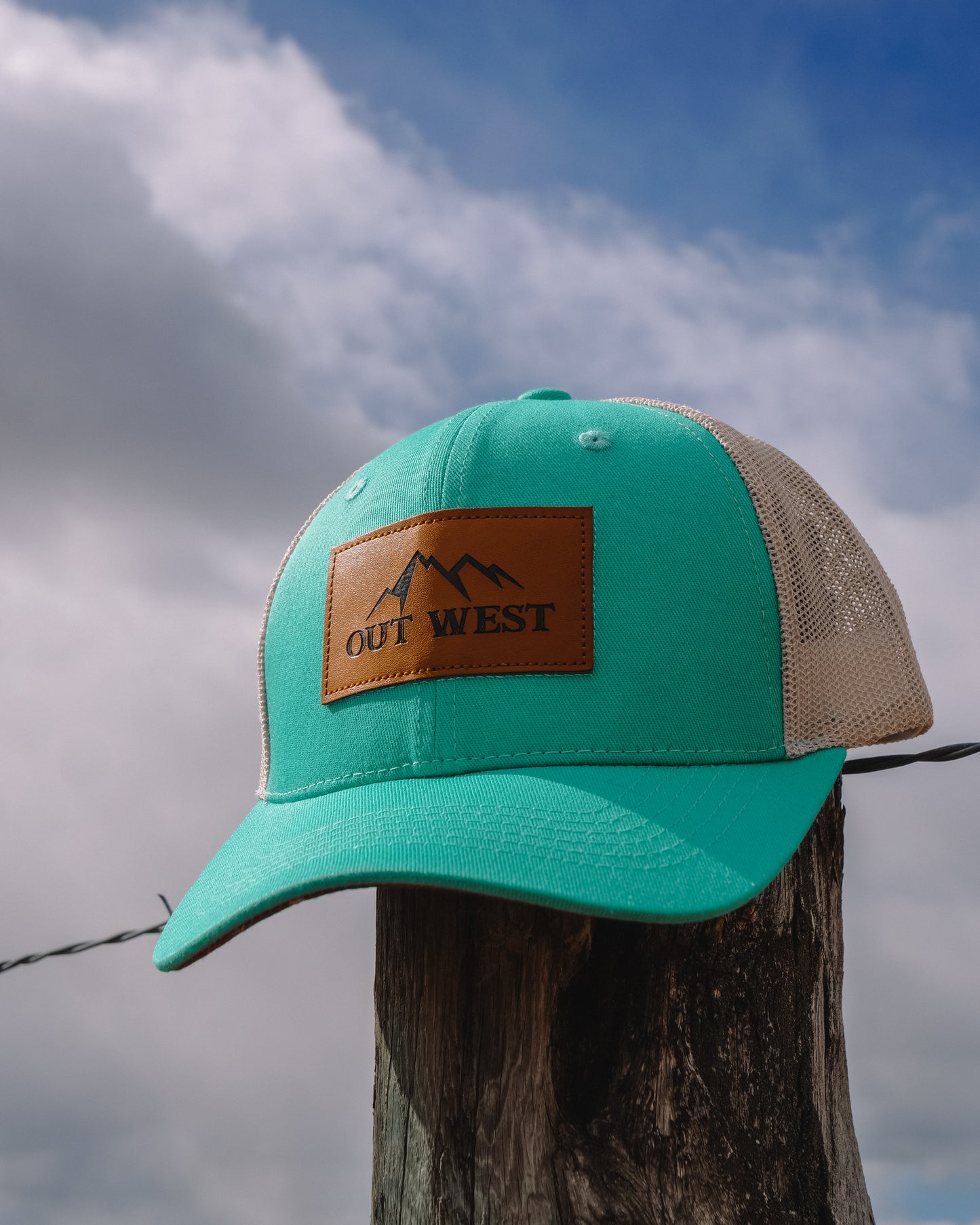 Out West ball cap in Aqua-  Our in-demand trucker caps are finally here + proudly designed by Out West! Not only fun & functional but truly a stylish staple piece for any rancher!  A gorgeous aqua color with a light cream mesh back & adjustable strap.