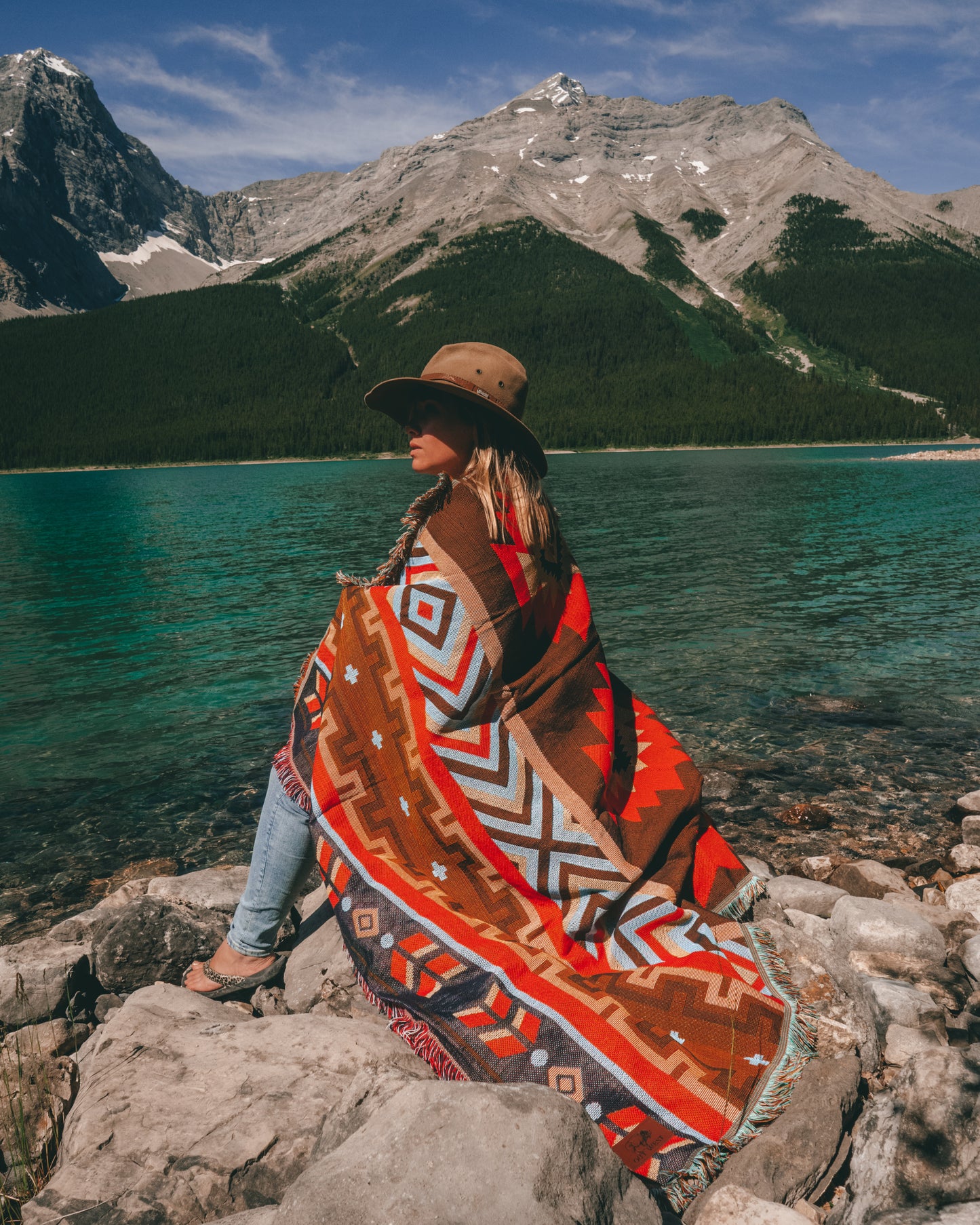 Aztec geometric western style throw rug- The perfect blanket for those cozy cold nights under the stars next to the campfire! Suited for every occasion from picnics, rodeos, camping, van life, yoga, and even beach trips! Or simply place it on your couch or bed for a splash of color to the room!  Color: Earthy brown and reds